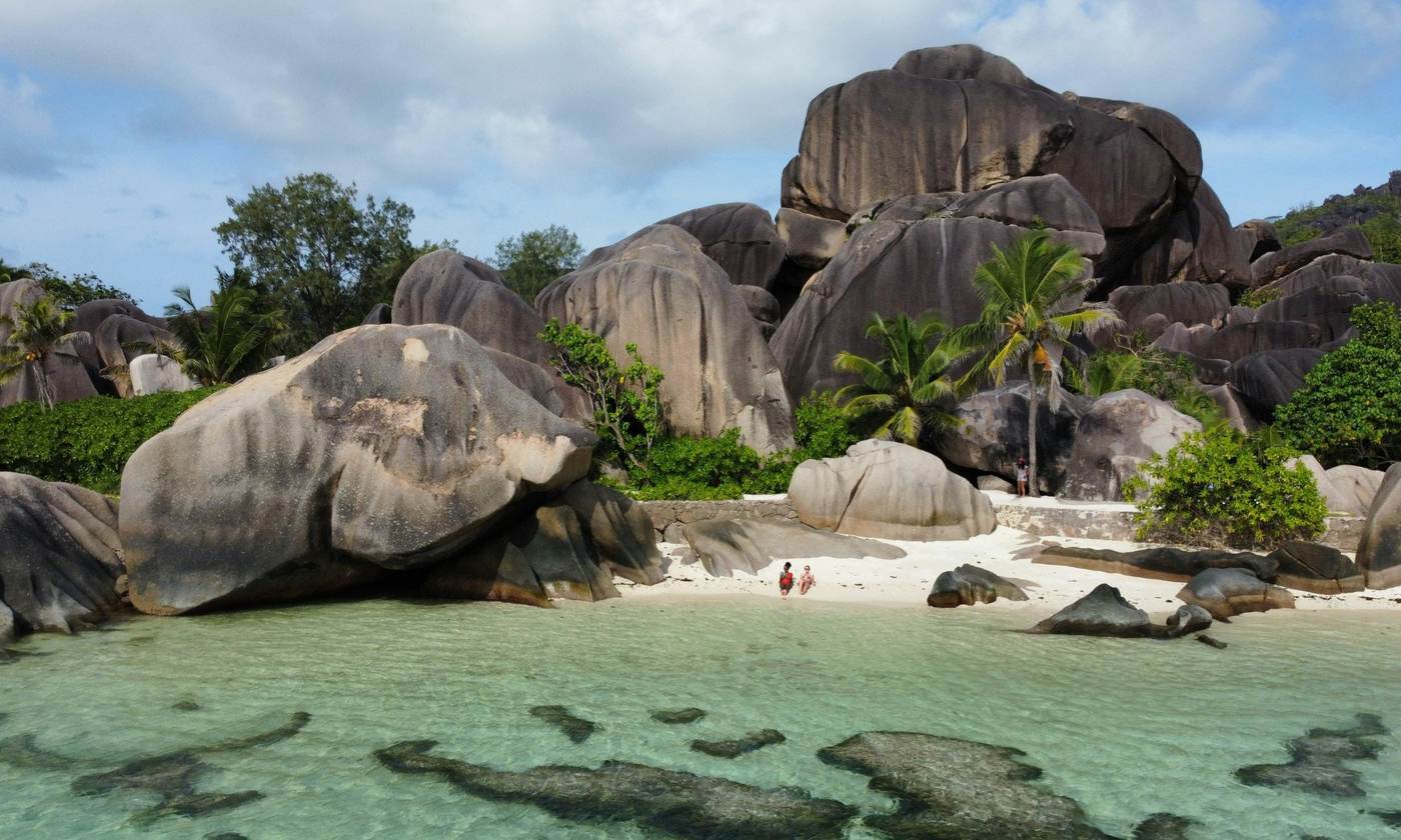 Huge granite boulders above a clear turquoise lagoon in the Seychelles